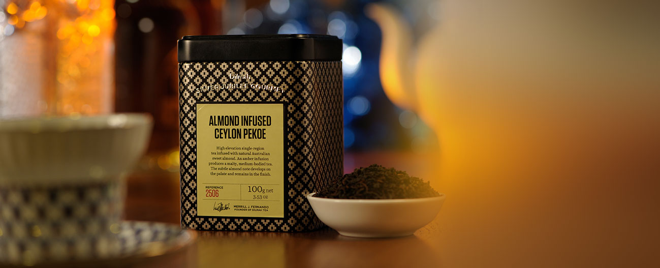 Container of Almond Infused Ceylon Pekoe Tea and Dried Tea Leaves