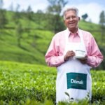 Dilmah founder Merril J. Fernando with a cup of tea in a tea garden