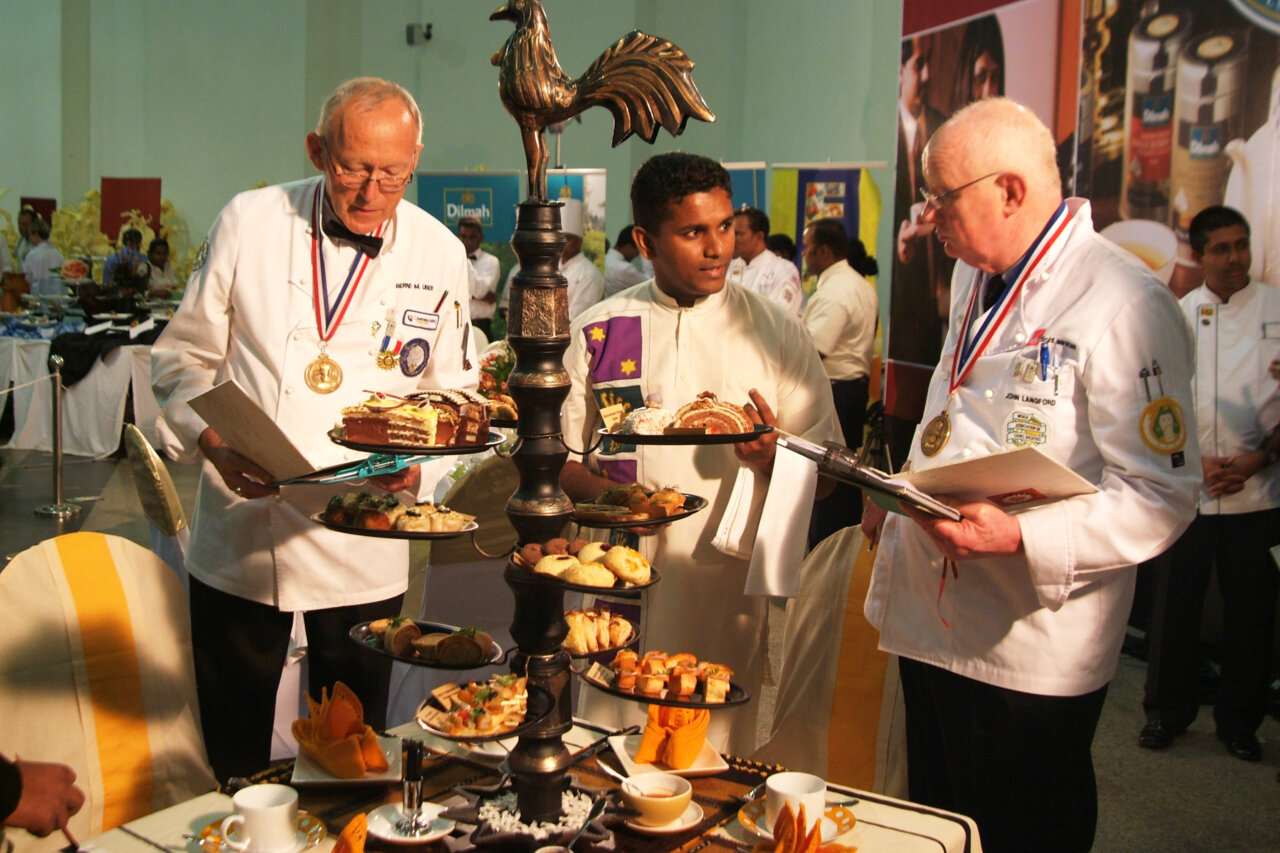 Three chefs assessing food
