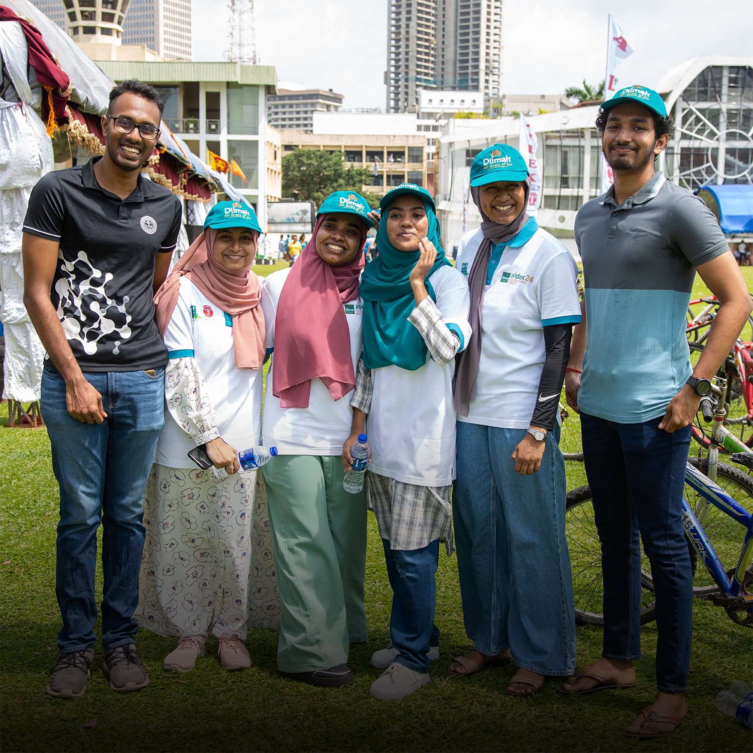 Two men and three women smiling at World Volunteer Day 2024