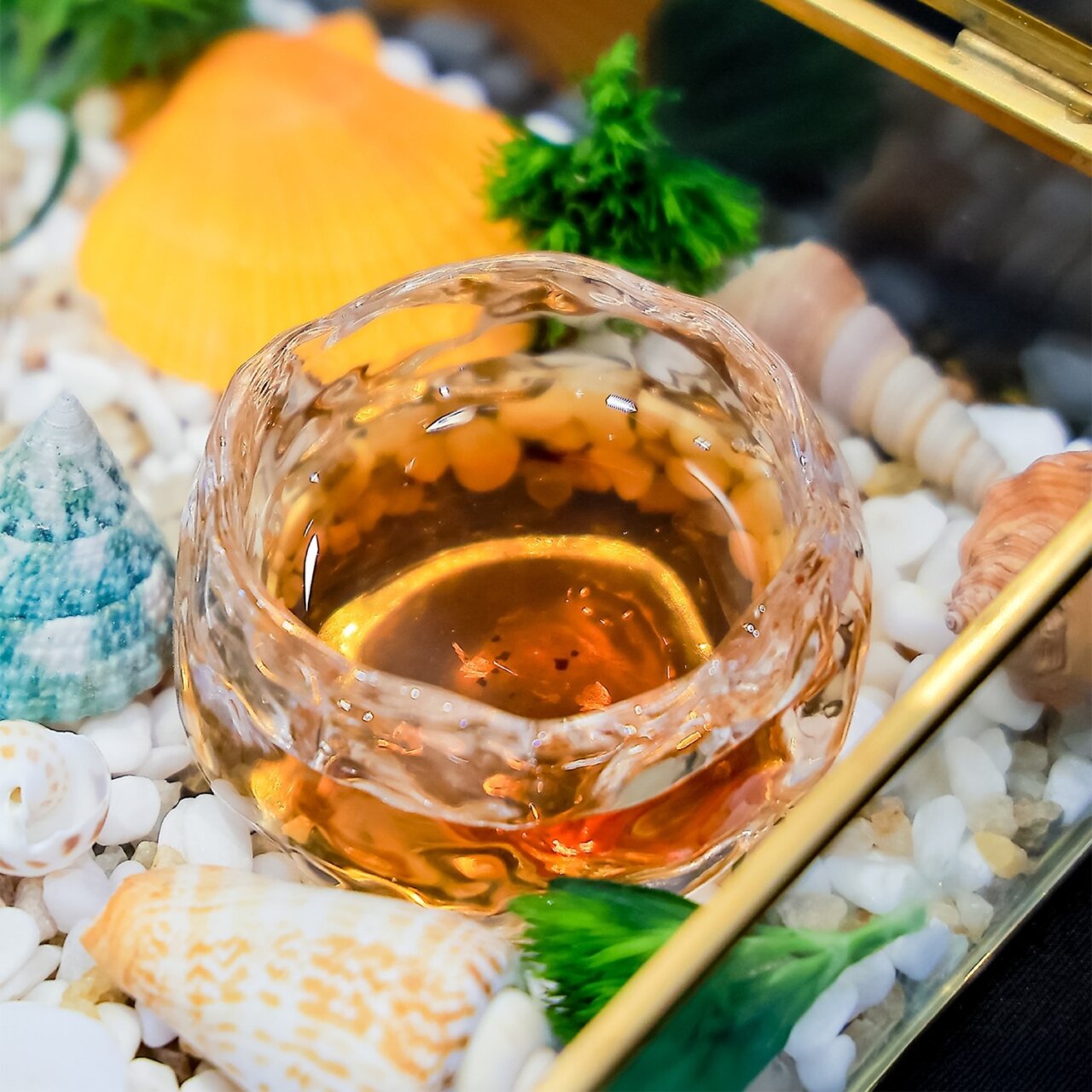 Glass with tea at Natural Luxury Sommelier Challenge